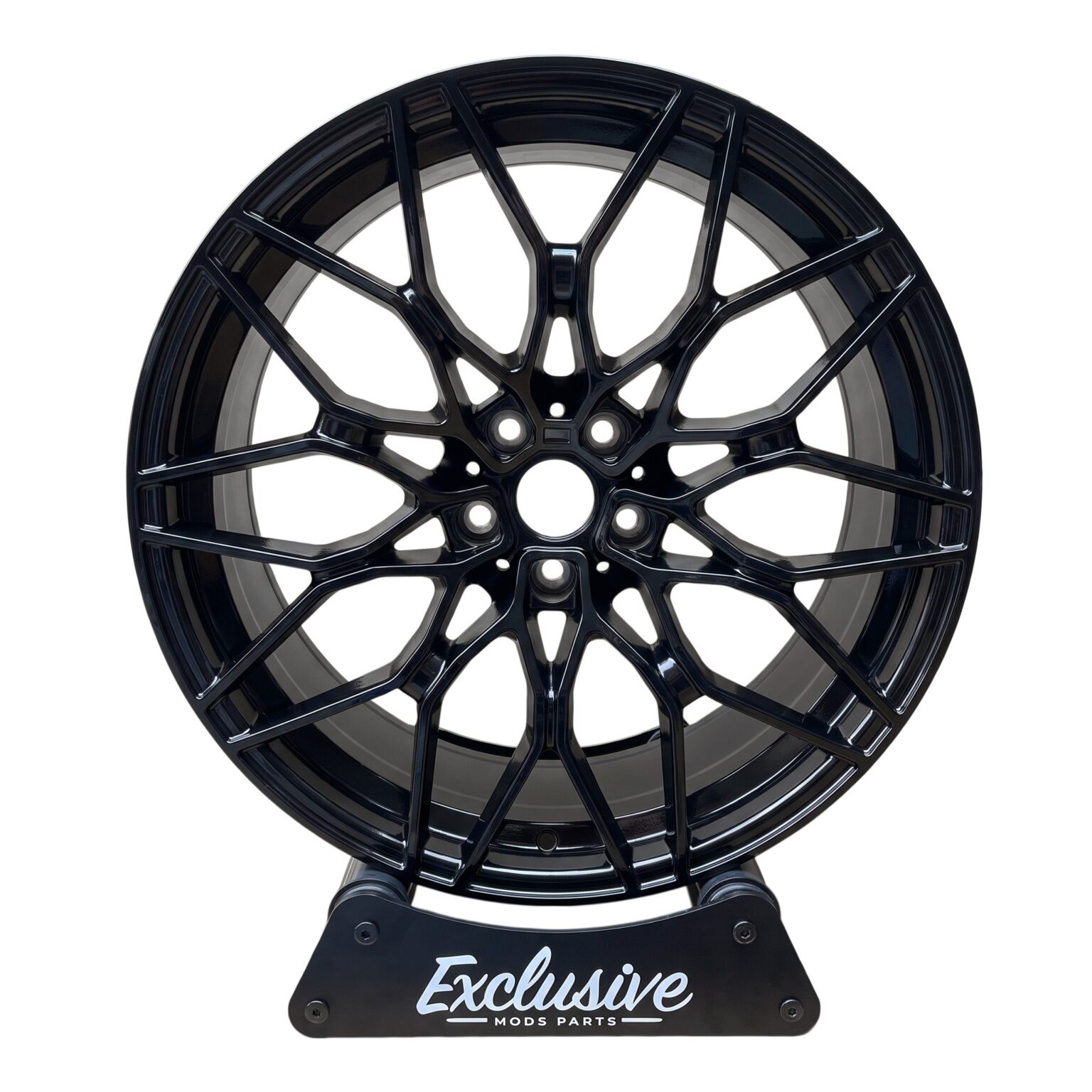 1000M style alloy wheel in gloss black on the Exclusive Mods Parts display stand, front view