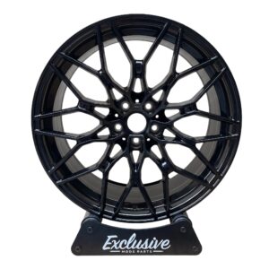 1000M style alloy wheel in gloss black on the Exclusive Mods Parts display stand, front view