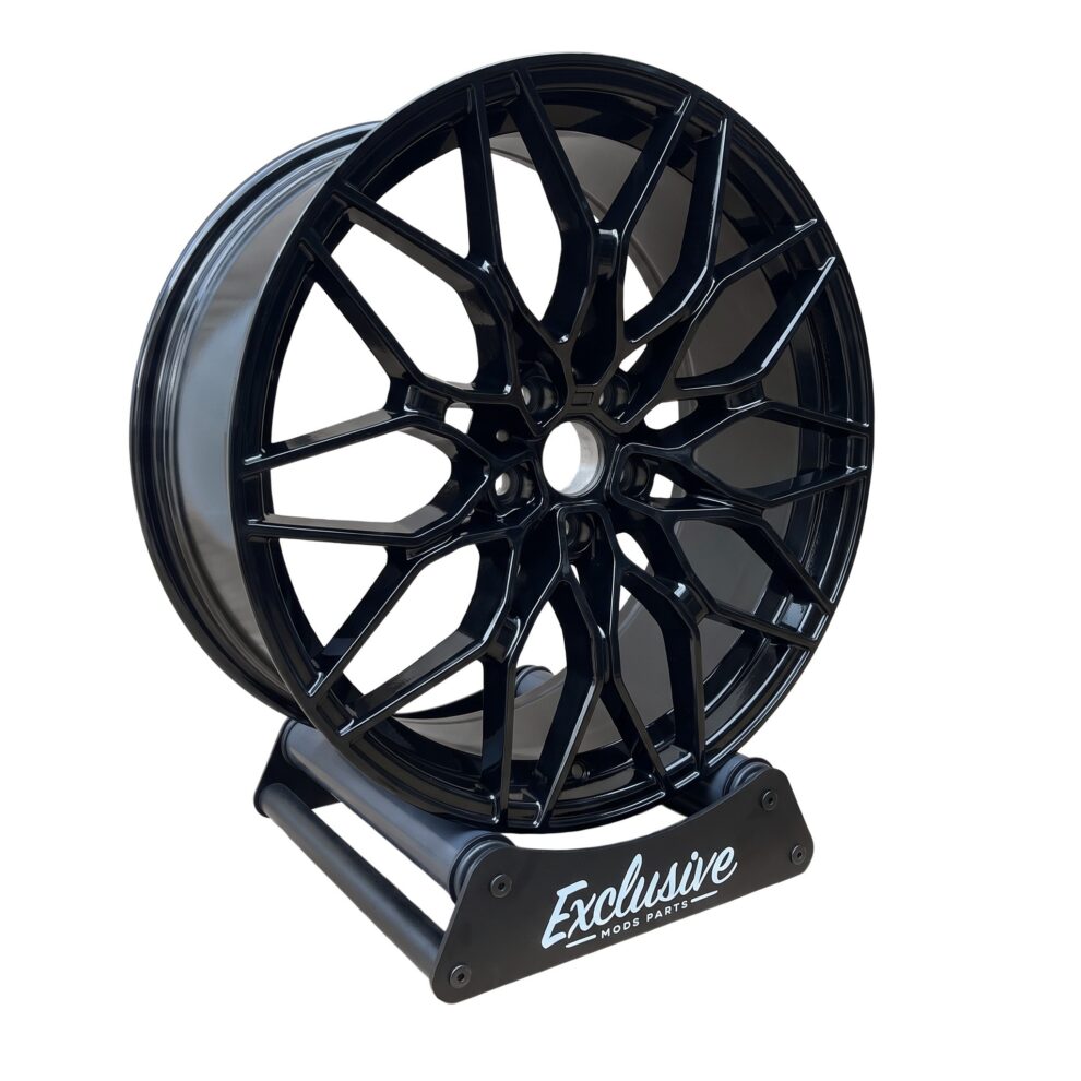 1000M style alloy wheel in gloss black on the Exclusive Mods Parts display stand, three-quarter view