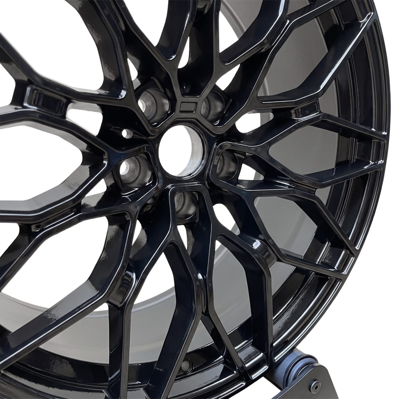 Close-up of the gloss black 1000M style alloy wheel spokes and centre bore