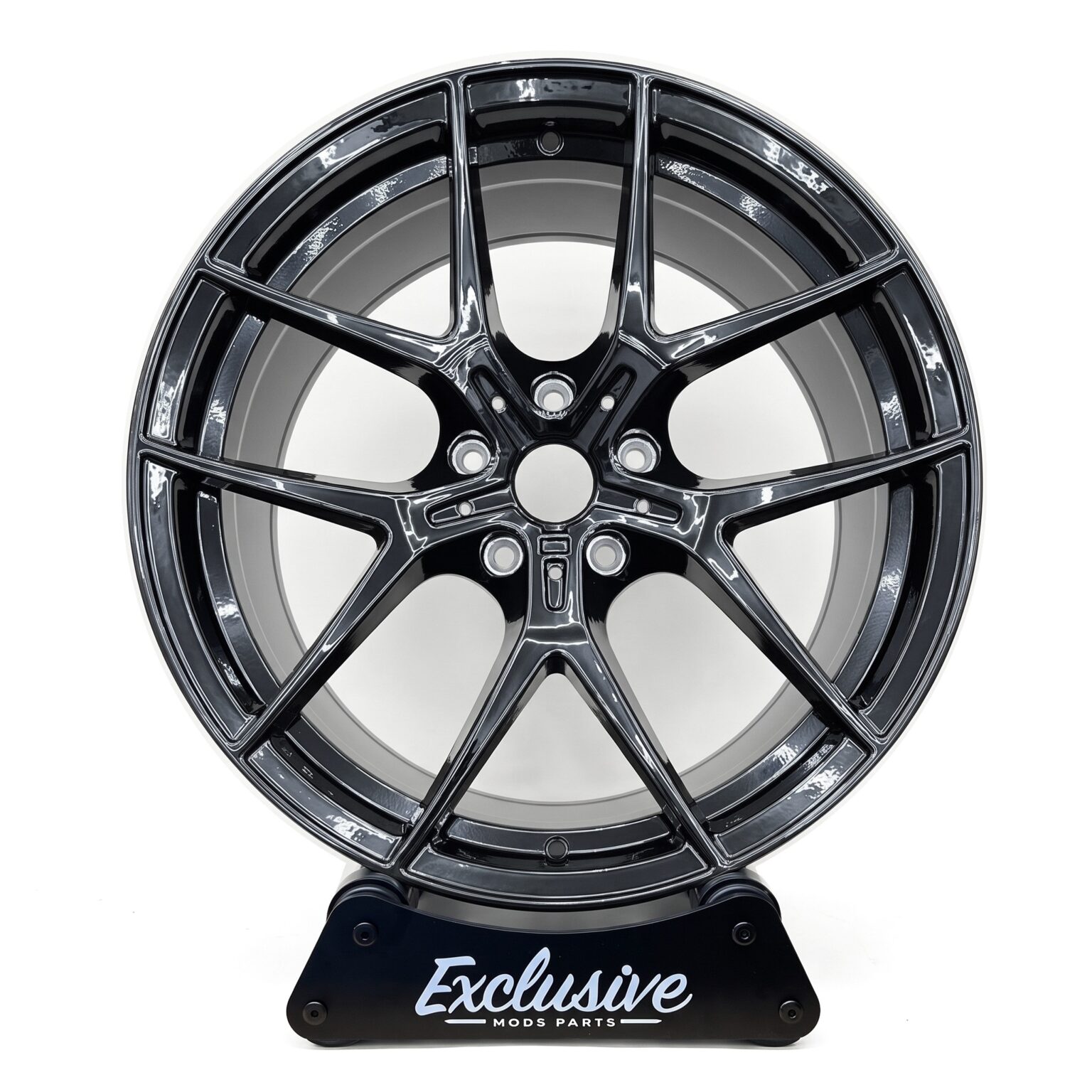 554M style alloy wheel in gloss black on the Exclusive Mods Parts display stand, front view
