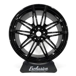 930M style alloy wheel in gloss black on the Exclusive Mods Parts display stand, front view