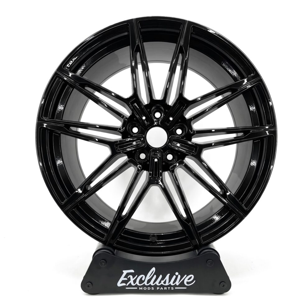 930M style alloy wheel in gloss black on the Exclusive Mods Parts display stand, front view