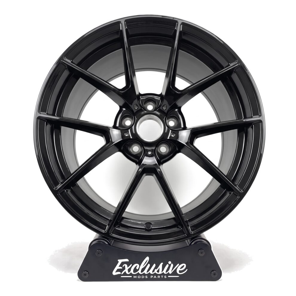 763M style alloy wheel in gloss black on the Exclusive Mods Parts display stand, front view