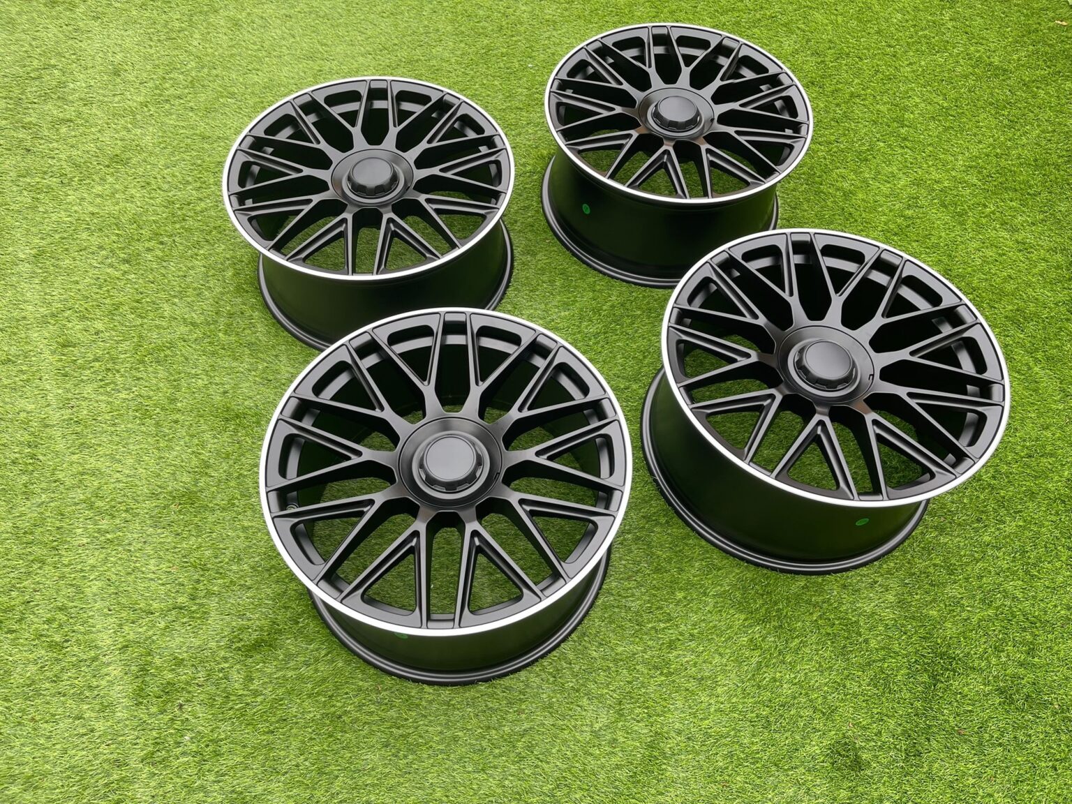 Set of four C63 AMG 10-Spoke Style satin black alloy wheels, angled view