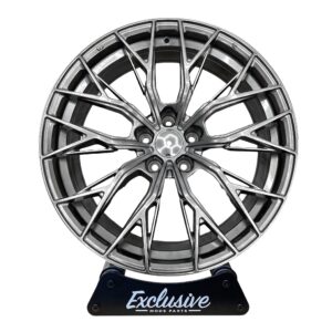 CR7 style alloy wheel in hyper black on the Exclusive Mods Parts display stand, front view