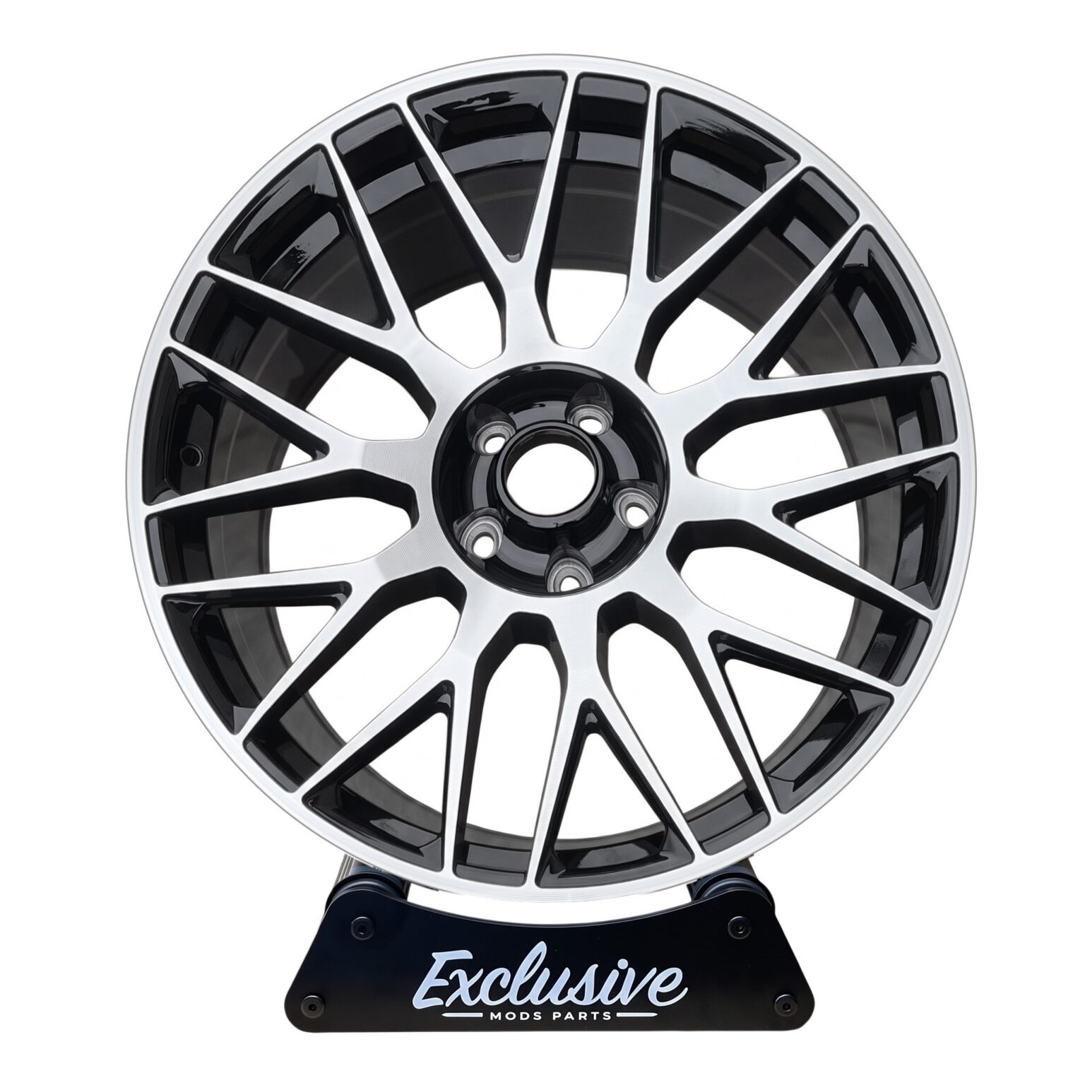 C63 AMG 10-spoke style alloy wheel, machined silver face with a gloss black centre, on the Exclusive Mods Parts display stand, front view