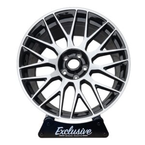 C63 AMG 10-spoke style alloy wheel, machined silver face with a gloss black centre, on the Exclusive Mods Parts display stand, front view