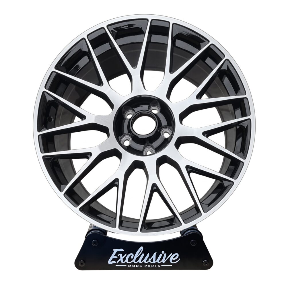 C63 AMG 10-spoke style alloy wheel, machined silver face with a gloss black centre, on the Exclusive Mods Parts display stand, front view