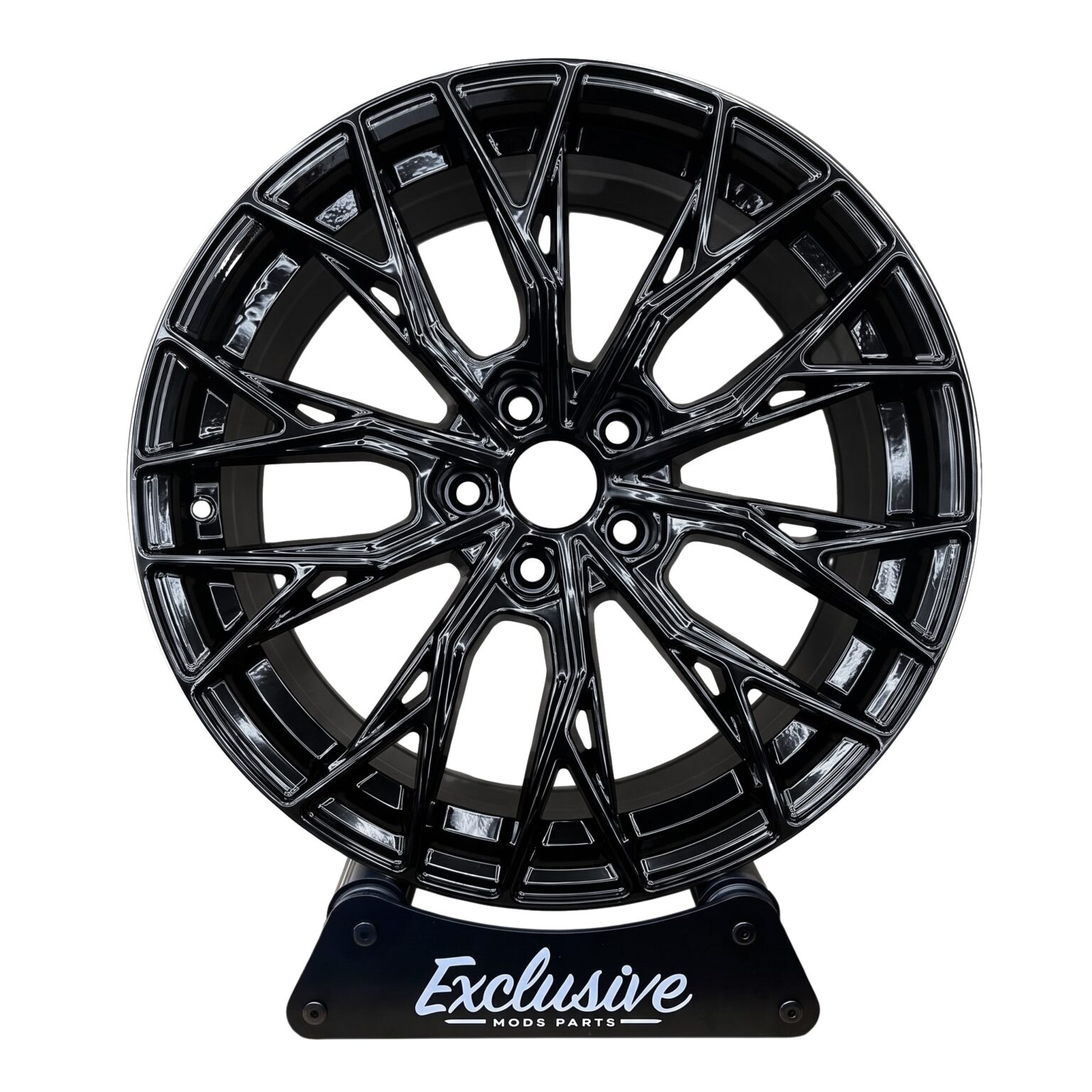 CR7 style alloy wheel in gloss black on the Exclusive Mods Parts display stand, front view