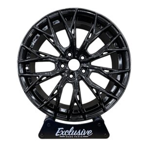 CR7 style alloy wheel in gloss black on the Exclusive Mods Parts display stand, front view